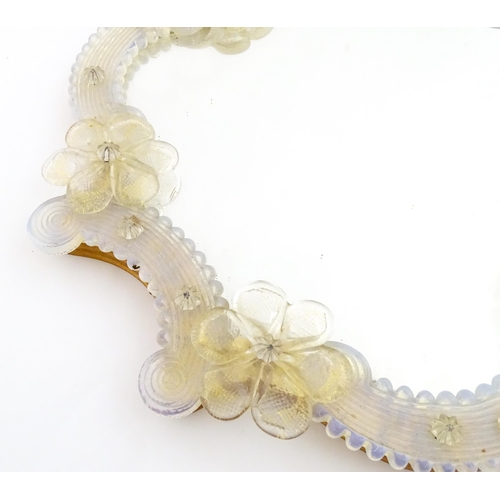 333 - An Italian / Venetian Murano framed mirror with applied glass flower detail. Approx. 13 1/2