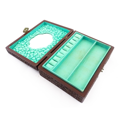 1042 - A 20thC Chinese jewellery box with cinnabar lacquer style scrolling floral decoration, opening to re... 