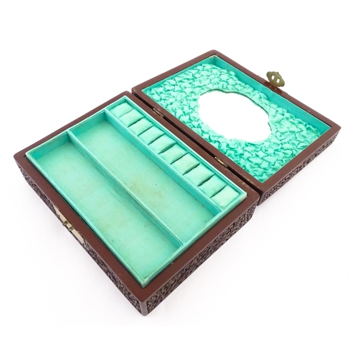 1042 - A 20thC Chinese jewellery box with cinnabar lacquer style scrolling floral decoration, opening to re... 