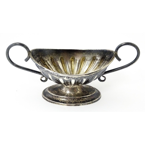 345 - A silver twin handled pedestal salt. Hallmarked Chester 1897 maker Florence Warden. Approx 4