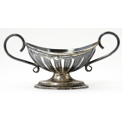 345 - A silver twin handled pedestal salt. Hallmarked Chester 1897 maker Florence Warden. Approx 4