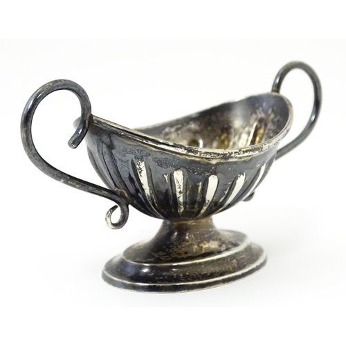 345 - A silver twin handled pedestal salt. Hallmarked Chester 1897 maker Florence Warden. Approx 4