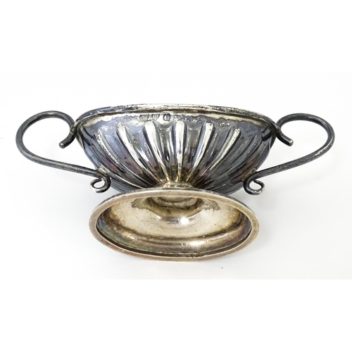 345 - A silver twin handled pedestal salt. Hallmarked Chester 1897 maker Florence Warden. Approx 4