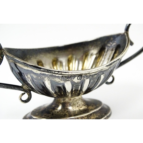 345 - A silver twin handled pedestal salt. Hallmarked Chester 1897 maker Florence Warden. Approx 4