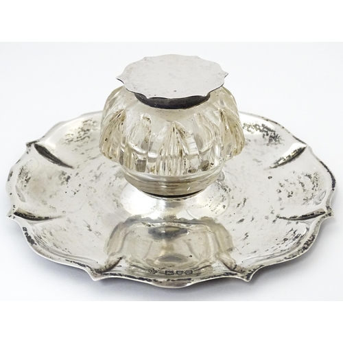346 - A Victorian cut glass inkwell on silver stand and with silver mounts and lid. Hallmarked London 1900... 