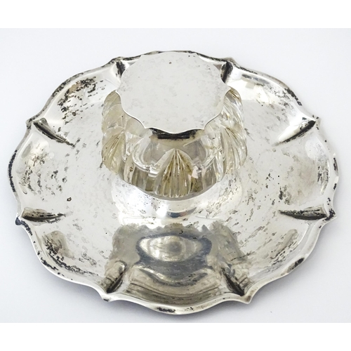 346 - A Victorian cut glass inkwell on silver stand and with silver mounts and lid. Hallmarked London 1900... 