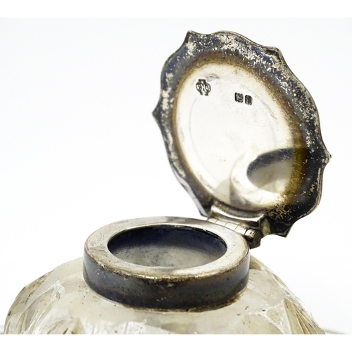 346 - A Victorian cut glass inkwell on silver stand and with silver mounts and lid. Hallmarked London 1900... 