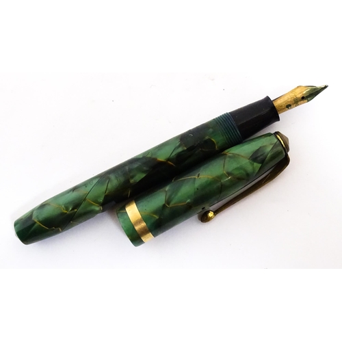 1137 - A Parker, England 'Duofold' fountain pen with 14k gold nib and green celluloid decoration. Together ... 