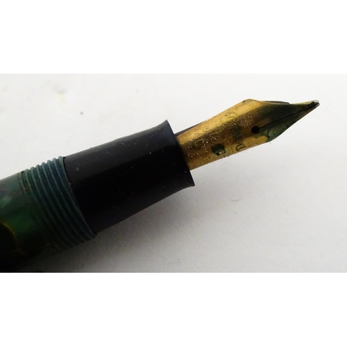 1137 - A Parker, England 'Duofold' fountain pen with 14k gold nib and green celluloid decoration. Together ... 