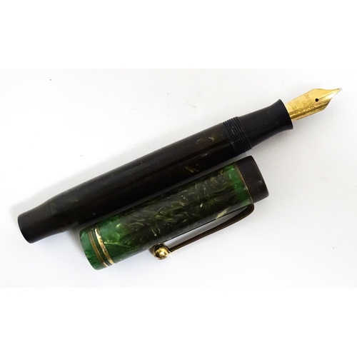 1137 - A Parker, England 'Duofold' fountain pen with 14k gold nib and green celluloid decoration. Together ... 