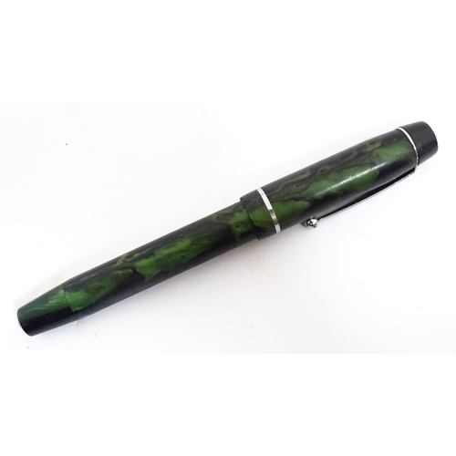 1140A - A Mentmore fountain pen with 14k gold nib and green celluloid finish. Together with a Bakelite prope... 