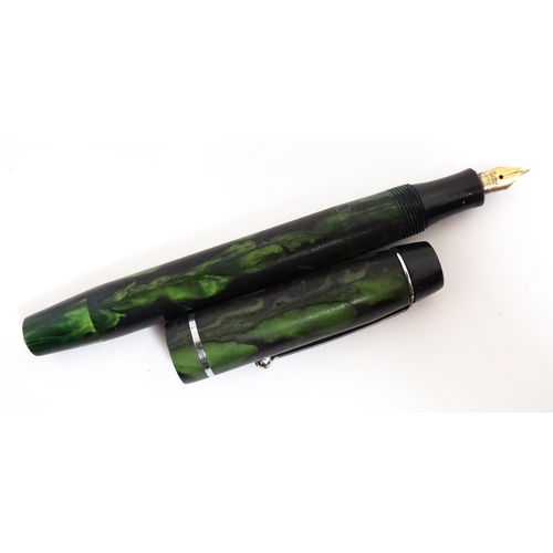 1140A - A Mentmore fountain pen with 14k gold nib and green celluloid finish. Together with a Bakelite prope... 