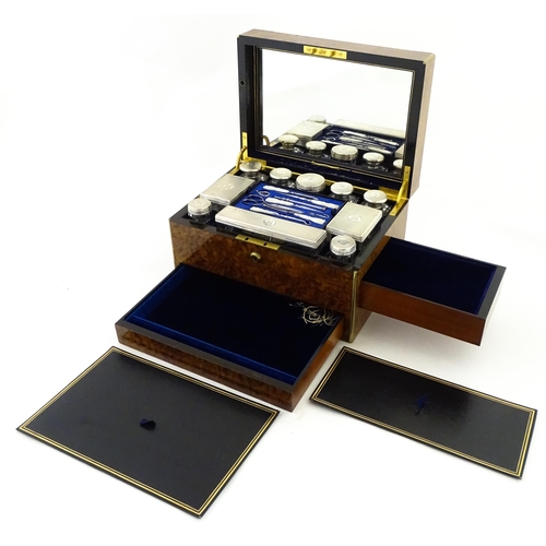 1142 - A Victorian brass bound walnut travelling vanity case / box with sprung section lower and to side, o... 