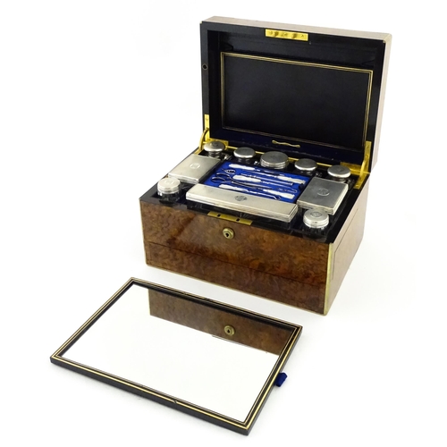 1142 - A Victorian brass bound walnut travelling vanity case / box with sprung section lower and to side, o... 