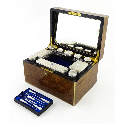 1142 - A Victorian brass bound walnut travelling vanity case / box with sprung section lower and to side, o... 