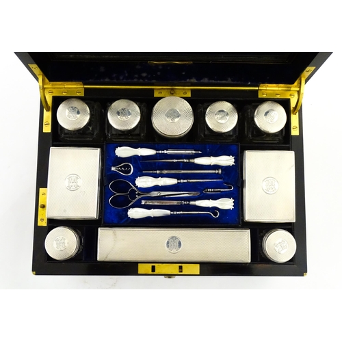 1142 - A Victorian brass bound walnut travelling vanity case / box with sprung section lower and to side, o... 