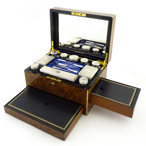 1142 - A Victorian brass bound walnut travelling vanity case / box with sprung section lower and to side, o... 