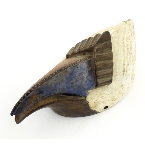 1180 - Ethnographic / Native / Tribal : An African bird mask with polychrome detail. Approx. 13 1/2