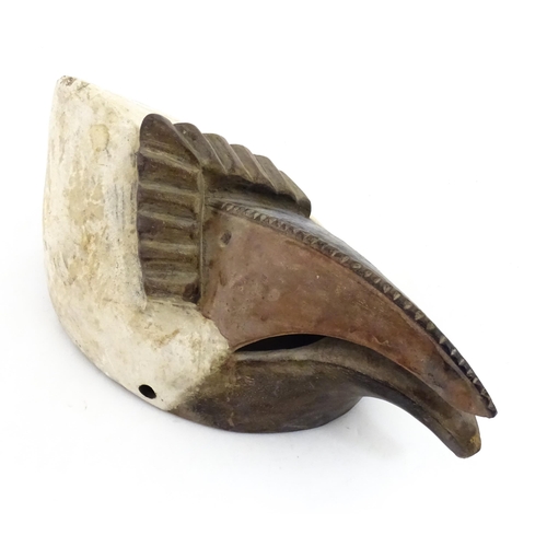 1180 - Ethnographic / Native / Tribal : An African bird mask with polychrome detail. Approx. 13 1/2