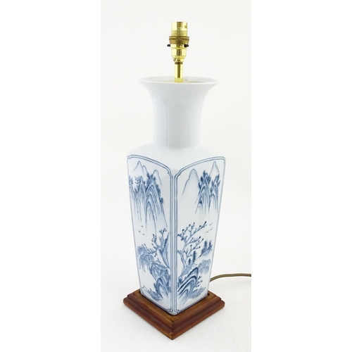 1395 - A Chinese blue and white table lamp of squared form with landscape decoration. Approx. 20