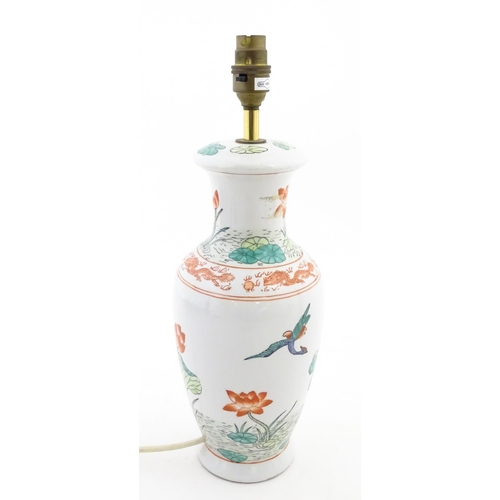 1401 - A Chinese table lamp decorated with lotus flowers and birds, with dragon and flaming pearl border. A... 