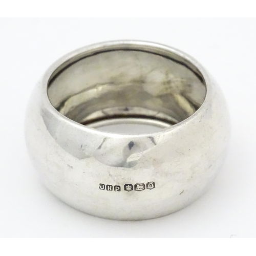 348 - A silver napkin ring hallmarked Sheffield 1931, maker John Henry Potter