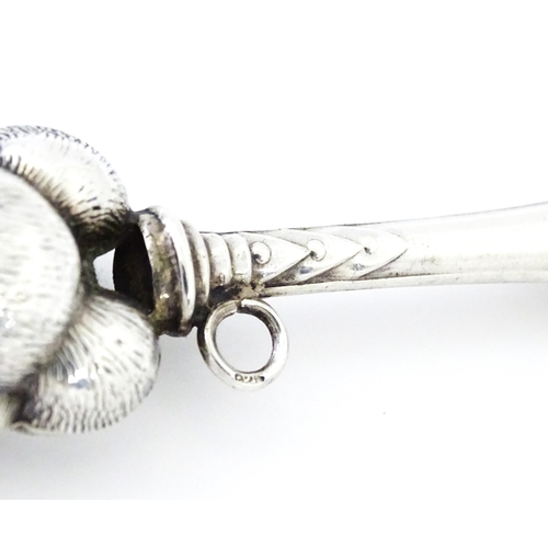 351 - A white metal child's rattle with teddy bear decoration. Approx. 4 1/2