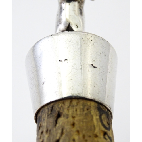 353 - A silver bottle stopper with bull finial. Approx. 2 3/4