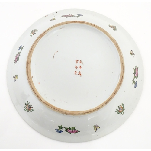 228 - A large Chinese Cantonese famille rose charger decorated with birds, flowers and butterflies. Charac... 
