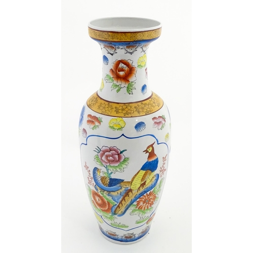 65 - A large Chinese vase decorated with birds and flowers. Marked under. Approx. 24