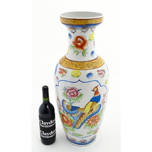 65 - A large Chinese vase decorated with birds and flowers. Marked under. Approx. 24