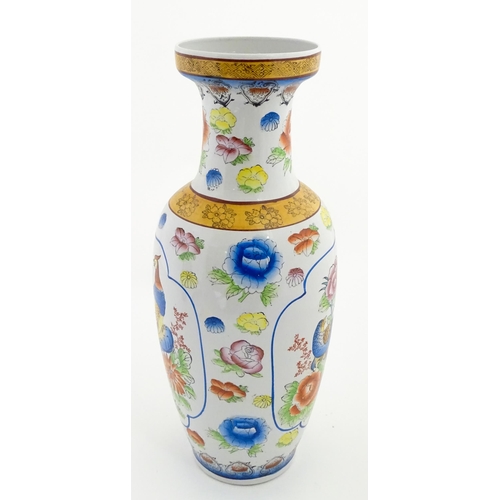 65 - A large Chinese vase decorated with birds and flowers. Marked under. Approx. 24