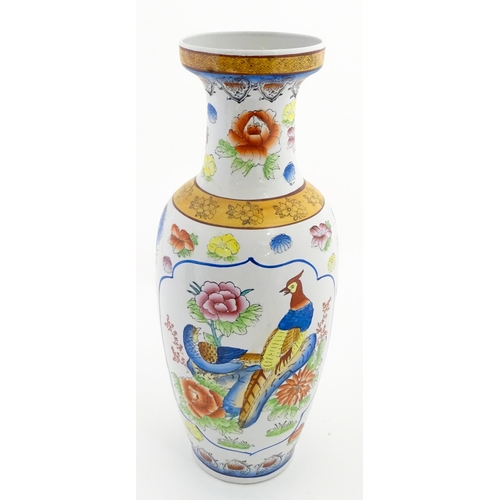 65 - A large Chinese vase decorated with birds and flowers. Marked under. Approx. 24