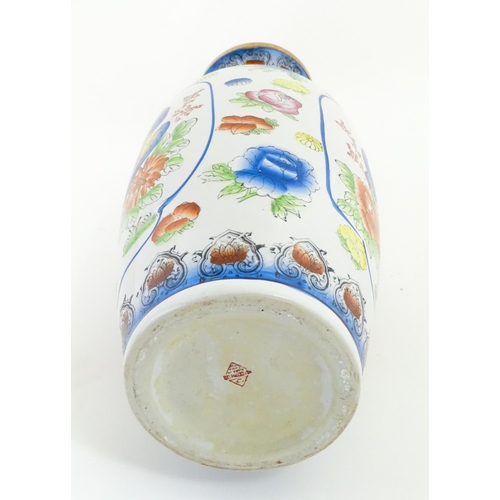 65 - A large Chinese vase decorated with birds and flowers. Marked under. Approx. 24