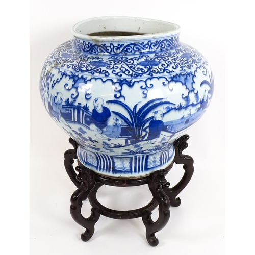 62 - A large Chinese blue and white jardiniere of bulbous form decorated with figures in a garden landsca... 