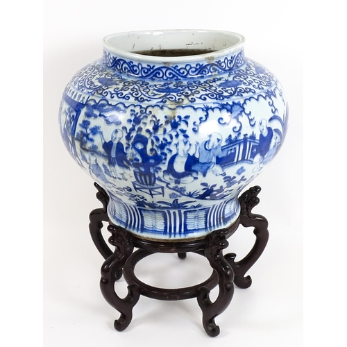 62 - A large Chinese blue and white jardiniere of bulbous form decorated with figures in a garden landsca... 