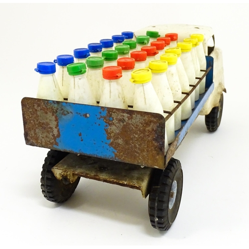 1320 - Toys: A tinplate Tri-ang Hi-way Milk Float / truck with milk bottles. Approx. 13 3/4