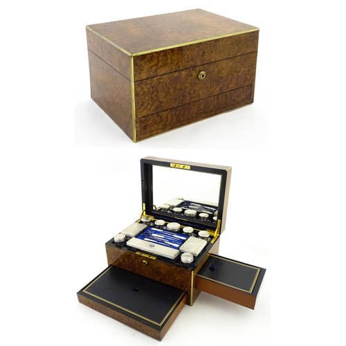 1142 - A Victorian brass bound walnut travelling vanity case / box with sprung section lower and to side, o... 