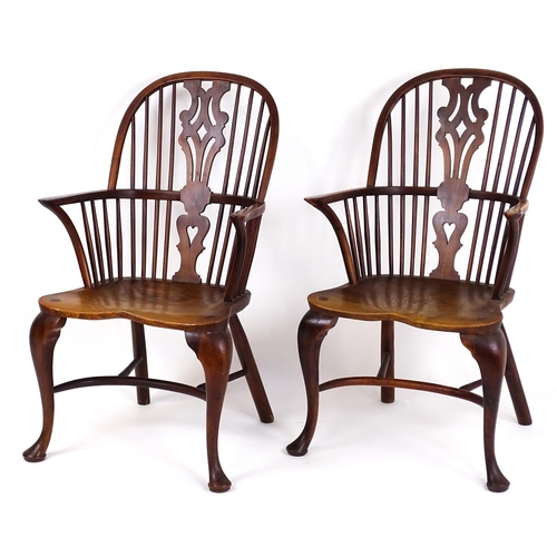 A pair of late 19thC double bow back yew wood Windsor chairs with tapering, pierced back splats, shaped elm seats and raised on cabriole front legs terminating in pad feet. 24" wide x 18" deep x 40" high.