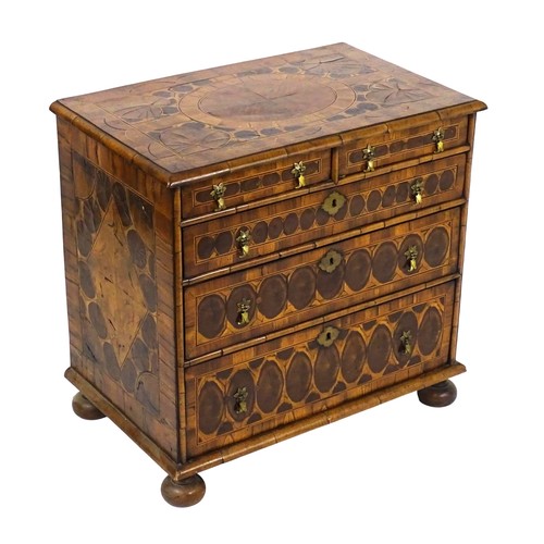 A 17thC and later oyster veneered walnut and laburnum chest of drawers with a moulded top and front containing two short over three long graduated drawers raised on squat bun feet. 31 1/2" wide x 20" deep x 30" high.