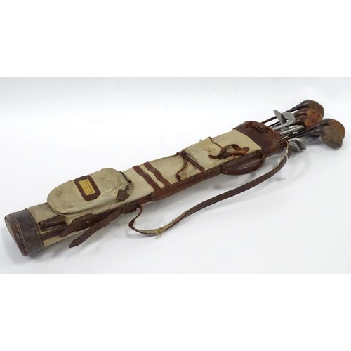 8 - A mid 20thC golf bag and clubs, including three hardwood drivers stamped 'Fred Whitting - Sandwich',... 