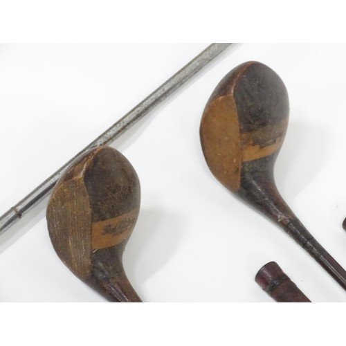 8 - A mid 20thC golf bag and clubs, including three hardwood drivers stamped 'Fred Whitting - Sandwich',... 