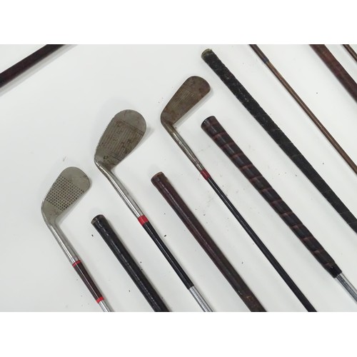 8 - A mid 20thC golf bag and clubs, including three hardwood drivers stamped 'Fred Whitting - Sandwich',... 