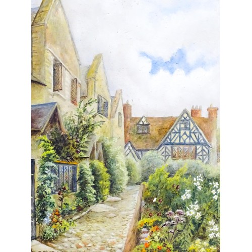 10 - A 20thC oil on board depicting and English village scene with houses and a cottage garden. Signed J ... 
