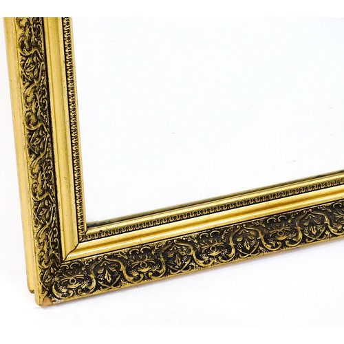 32 - A modern mirror with a gilt moulded frame and bevelled glass centre. 52
