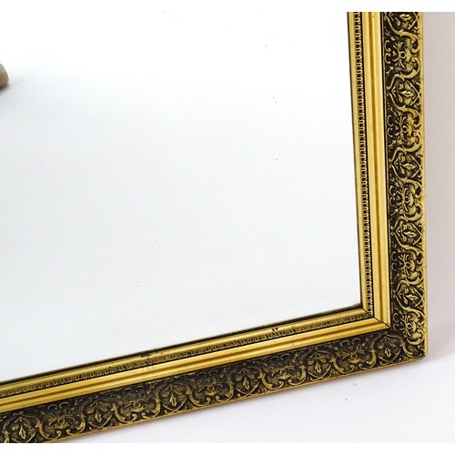 32 - A modern mirror with a gilt moulded frame and bevelled glass centre. 52