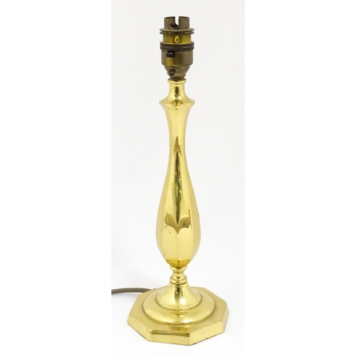 40 - A 20thC brass table lamp raised on an octagonal base. Approx. 12 1/2