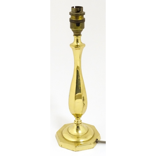 40 - A 20thC brass table lamp raised on an octagonal base. Approx. 12 1/2