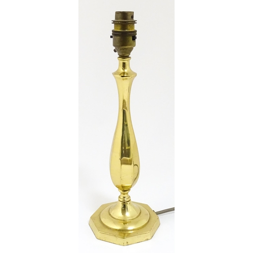 40 - A 20thC brass table lamp raised on an octagonal base. Approx. 12 1/2
