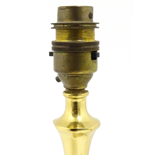 40 - A 20thC brass table lamp raised on an octagonal base. Approx. 12 1/2